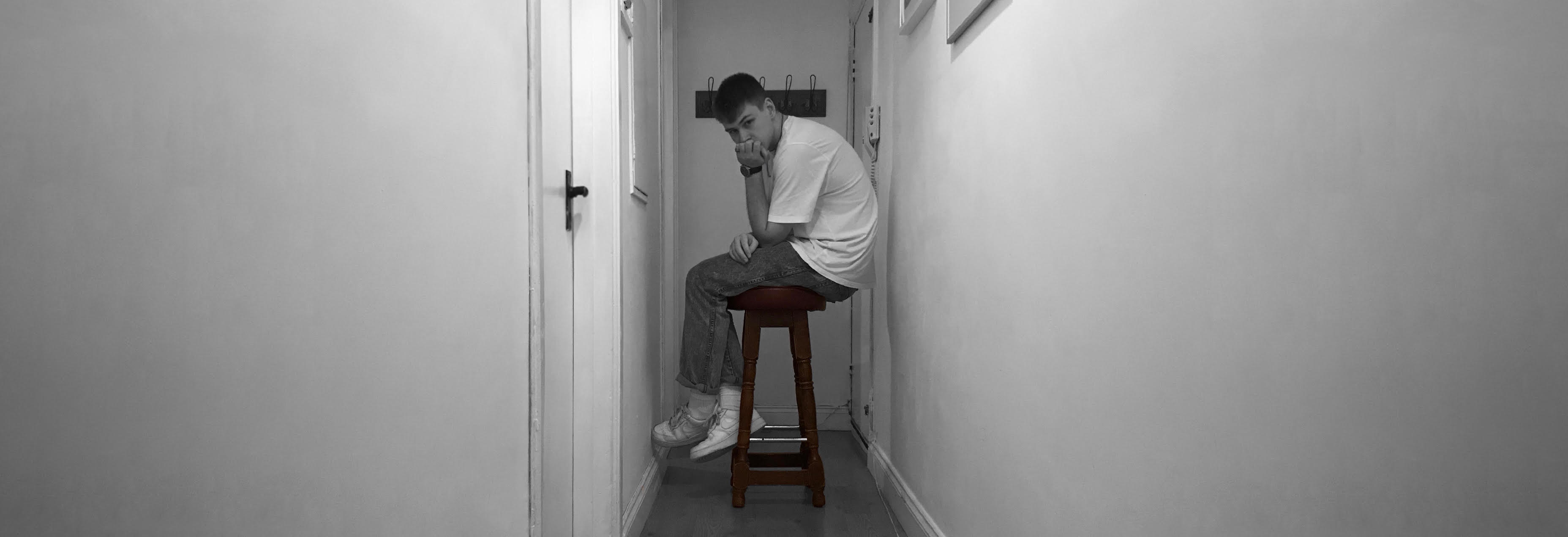 Lew standing in a hallway